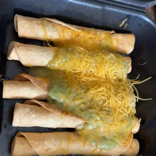 Rolled tacos with cheese and guacamole