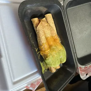 Rolled tacos with cheese and guacamole