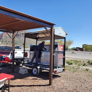 a man setting up a hot dog cart