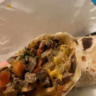 a hand holding a burrito