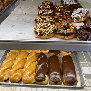 Chocolate glaze donuts with nuts, sprinkles, coconut