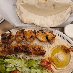 Chicken plate with fresh baked bread.