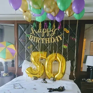 Mardi Gras Style birthday set up, with beads, masks and 2nd line umbrella