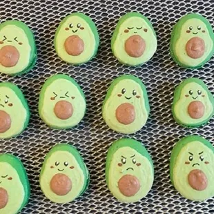 Custom avocado macarons with different facial expressions. Customize your own macarons by requesting on our website.