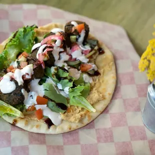 a taco with lettuce and sauce