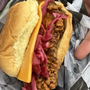 a person holding a sandwich in their hand