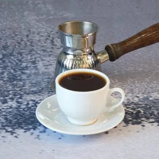 a cup of coffee on a saucer