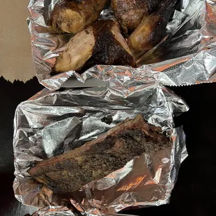 two pieces of meat wrapped in foil