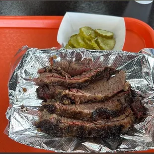 a tray of meat and pickles