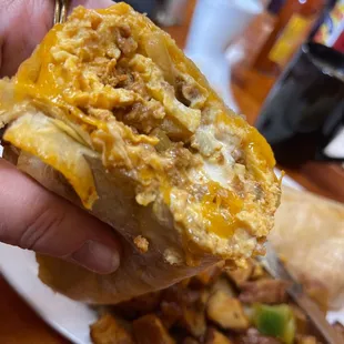 Spicy Chorizo Burrito, forget the potatoes, add extra cheese, salsa and sour cream all together. Yummy!
