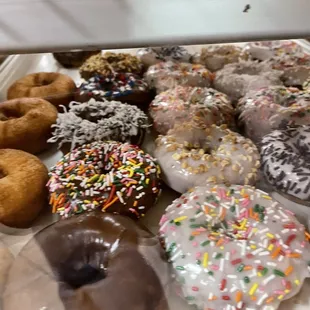 a variety of doughnuts in a display case