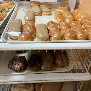 a variety of doughnuts in a display case
