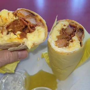 a hand holding a burrito