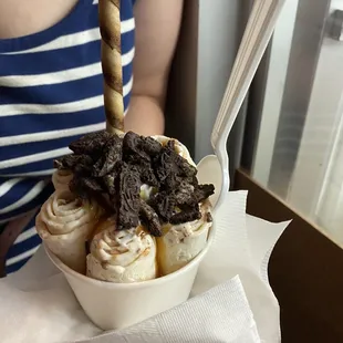 a person holding a bowl of ice cream