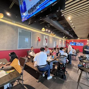 people sitting at tables in a restaurant