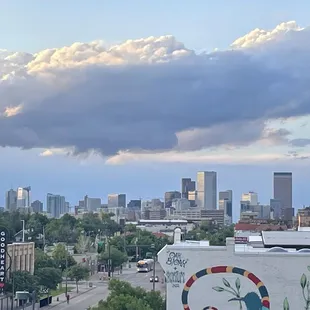 a city skyline with a mural on the side of a building