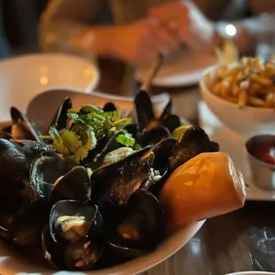 a plate of mussels and fries