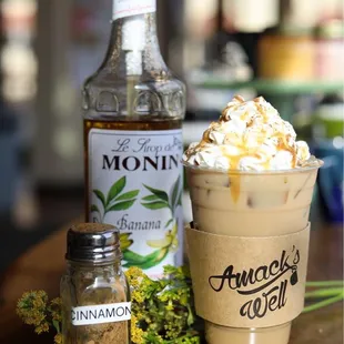 a cup of coffee and a bottle of alcohol