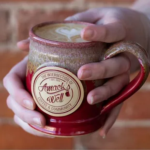 a person holding a cup of coffee