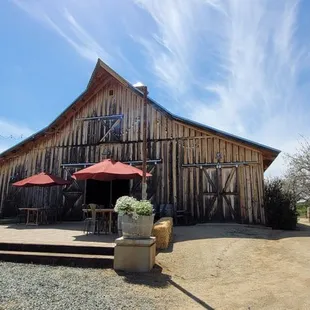 a wooden building with red umbrellas