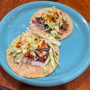 two tacos on a blue plate