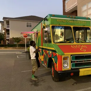 a man standing in front of a food truck