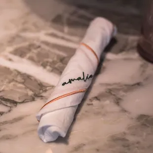 a folded napkin on a marble table