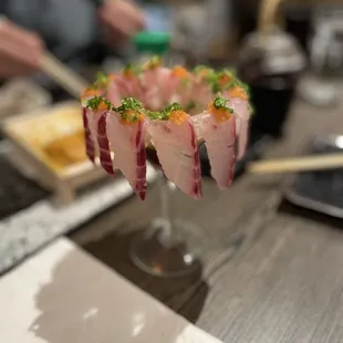 a person preparing a sushi