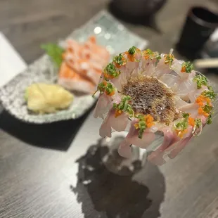 a hand holding a piece of sushi