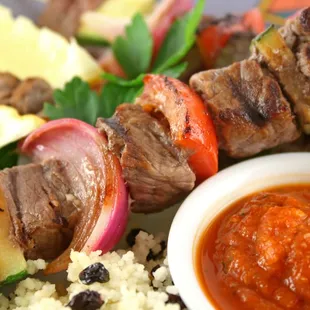 a plate of meat skewers