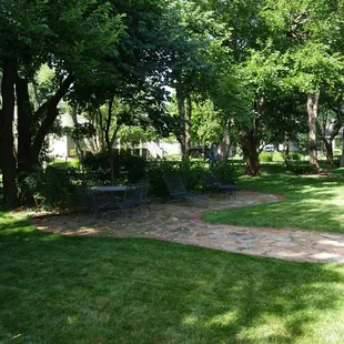 This shaded, luscious green backyard is perfect for relaxing and enjoying time with family and friends.