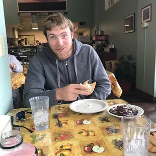 a man sitting at a table eating