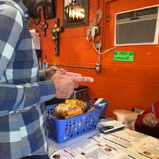 a man standing in front of a table with donuts