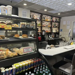 a view of a bakery counter with a variety of food items