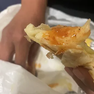 a person holding a piece of food