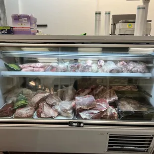 a display case with meat in it
