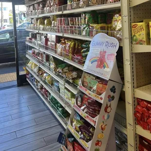 a grocery store aisle with a variety of snacks