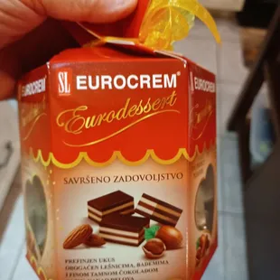 a hand holding a box of chocolates