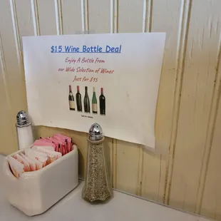 a bottle of wine, salt and pepper shakers