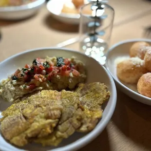 Smoked fish dip and tostones (left) and yuca cheese puffs (right)