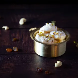 a small metal bowl filled with food