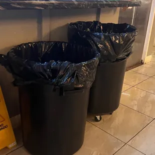 Open trash bin right next to where tables are