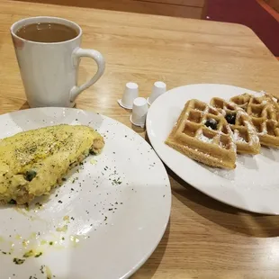 Seafood omlete and waffle topped with blueberries