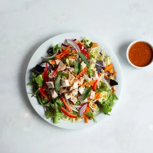 a plate of salad with dressing