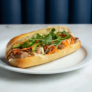 Chicken Num Pang, grilled chicken with house pickled veggies in a fresh, artisan baguette.