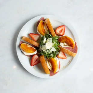 Grilled Peach Burrata - salami, strawberries, stacked on a grilled crostini, on a bed of arugula with honey and parmesan.