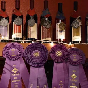 a row of wine bottles with ribbons