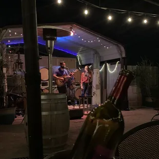 a man playing guitar in a barrel