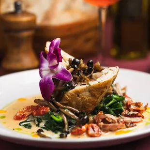 Chicken Amarone: Tender chicken rolled with fontina, prosciutto, and seasonal mushrooms, smothered in a creamy sauce.