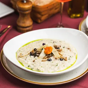 Mushroom Risotto: Creamy risotto featuring seasonal mushrooms, crème fraîche, and aged Parmesan.